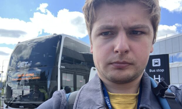 Finn Nixon with the new St Andrews to Edinburgh Airport bus. Image: Finn Nixon/DC Thomson