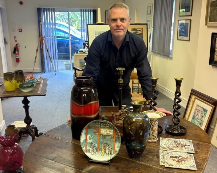 Owner of Gateway Gallery in Perth with some of his artwork