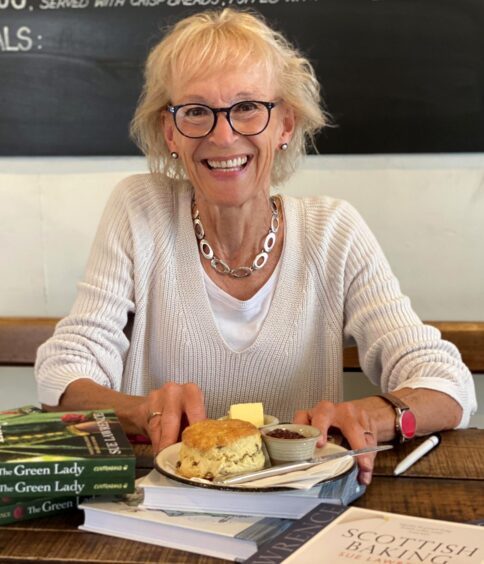 image shows: author and food writer Sue Lawrence with a plate of scones and two of her books.