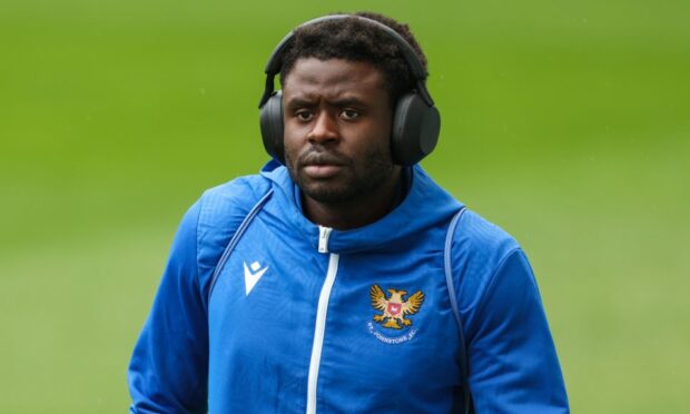 Benji Kimpioka with his headphones on before a game at Hibs.
