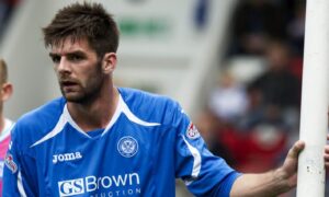 Cillian Sheridan leaning on a post before a corner.