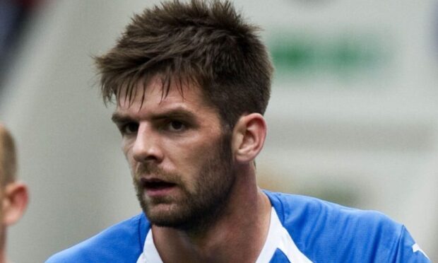 Cillian Sheridan leaning on a post before a corner.