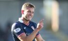 Jamie Gullan points to a Raith Rovers team-mate, while smiling.