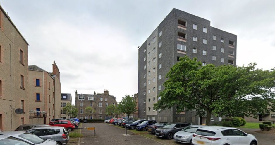 Car park with multistorey housing block behind
