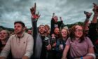 Crows at music festival pumping fists in air