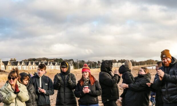 CR0051940, Rebecca Baird, Broughty Ferry, Relight Church baptism event, where people will be baptised in the Tay on Broughty Ferry beach down from the castle. Picture shows; Relight Church gather on Broughty Ferry beach to pray before the baptisms Saturday 8th February, 2025. Image: Mhairi Edwards/DC Thomson