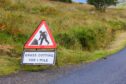 UK Triangle road sign warning of grass cutting for one mile