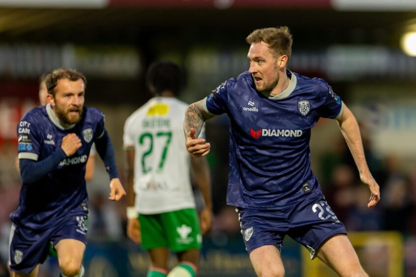 Kevin Holt celebrates after scoring for Derry City against Cork City, as ex-Dee Paul McMullan looks on