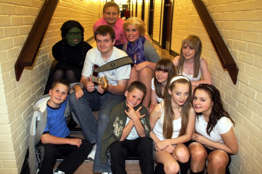 Some of the youngsters who took part in the talent show pose for a picture on some stairs.