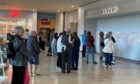 The shutters remained down as shoppers waited to go into Frasers on Friday morning. Image: Rob McLaren/DC Thomson