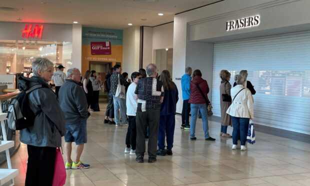 The shutters remained down as shoppers waited to go into Frasers on Friday morning. Image: Rob McLaren/DC Thomson