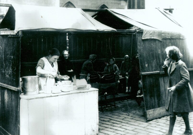 A woman serving up chips.