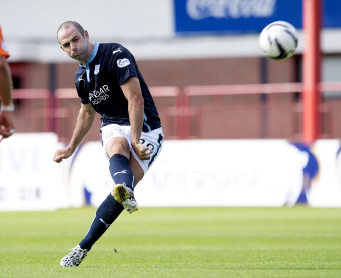 Gary Harkins kicks the ball while playing for the Dark Blues