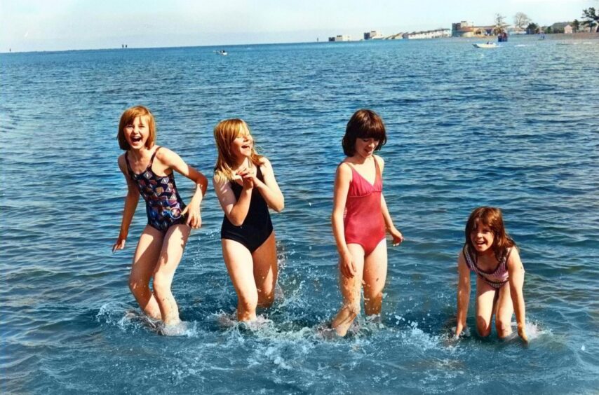 Four children in the water at Clatto Park.