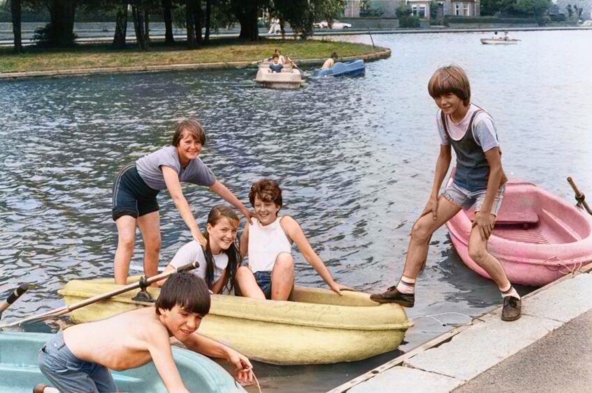Children in boats at Stobsmuir Pond. 