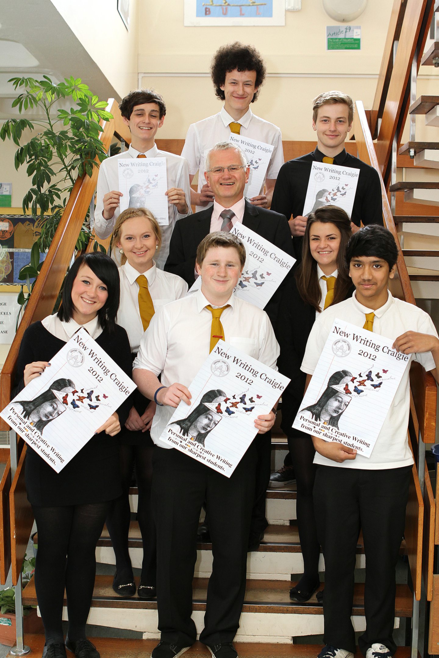 Pupils pose for a pic on a stairway at the magazine launch.