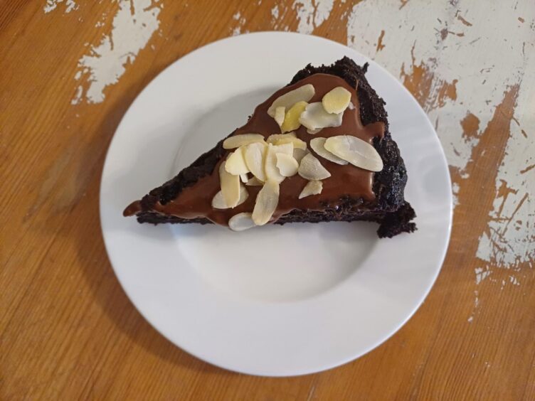 A slice of chocolate cake served on a plate.