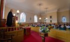 The Rev. Brian Ramsay, the last minister at Guthrie Church, leads the special service. Image: Paul Reid