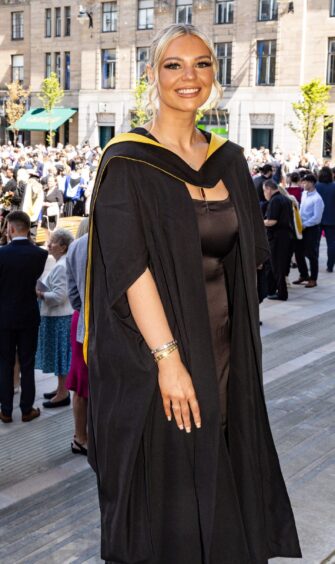 A Dundee University graduate poses outside Caird Hall.