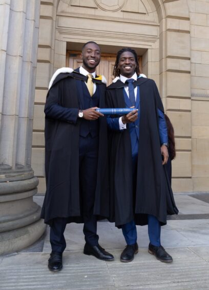 Two male graduates smiling at Dundee University's 2025 Graduations.