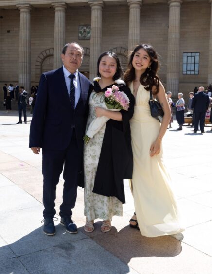 A female graduate with proud family members. 