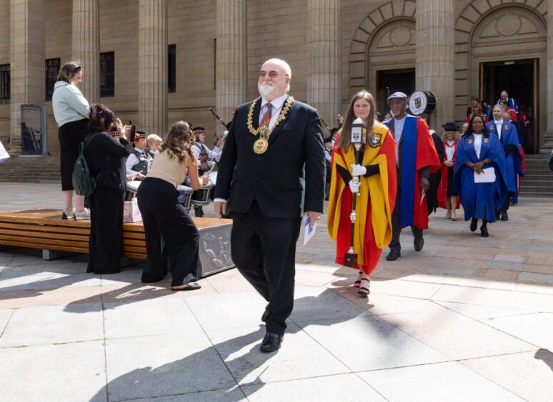 Lord Provost Bill Campbell leads graduates from Caird Hall. 