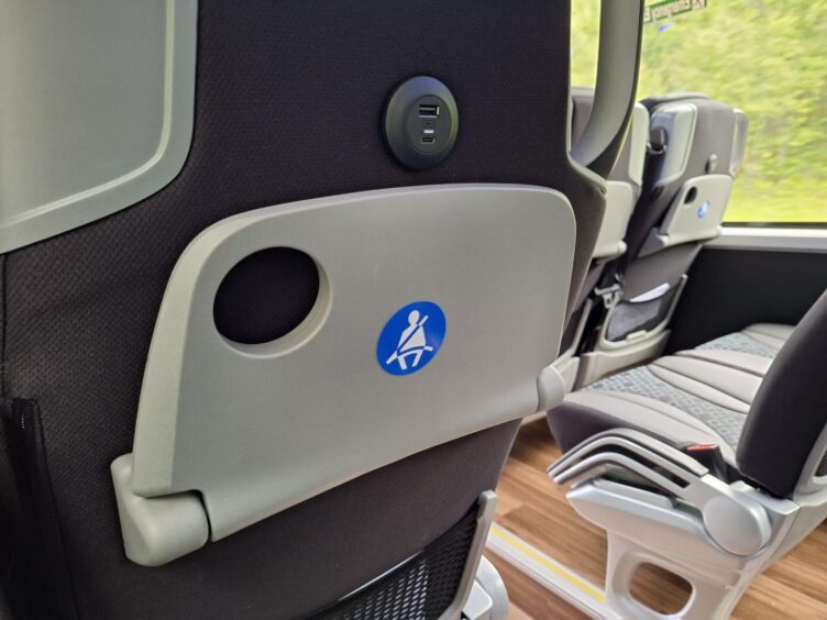 The back of a seat fitted with a charging port. 