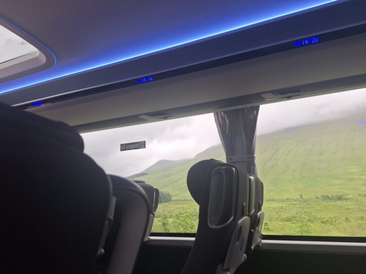 Mist rolling over hills viewed from the bus. 