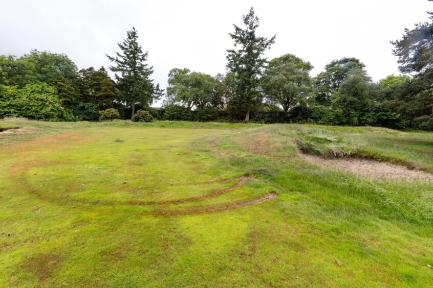 Tyre tracks spoil one of the old greens. 