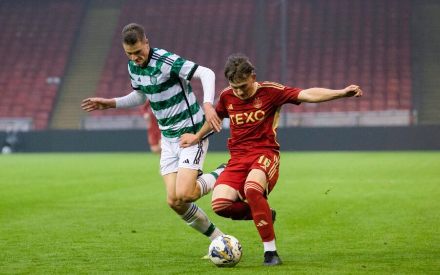 Alasdair Davidson challenges for a ball playing for Celtic under-18s against their Aberdeen counterparts.