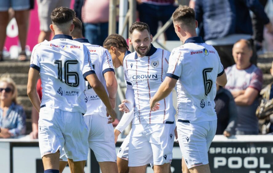 Wright is congratulated by team-mates. Image: Ross Parker/SNS