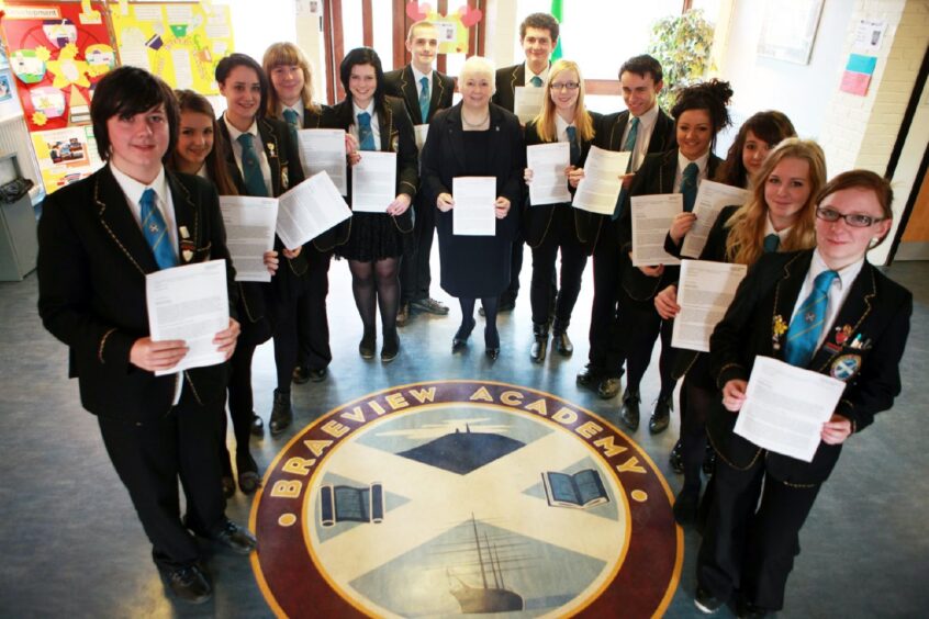 Education convenor Liz Fordyce joined prefects gathered around the Braeview Academy seal in the foyer