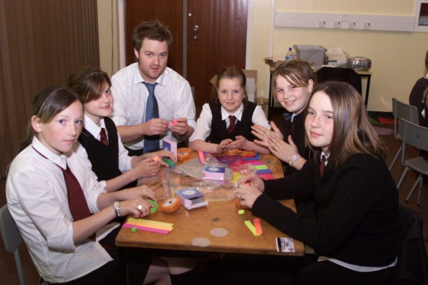 Pupils sit around a table with Gavin Oattes from tree of knowledge