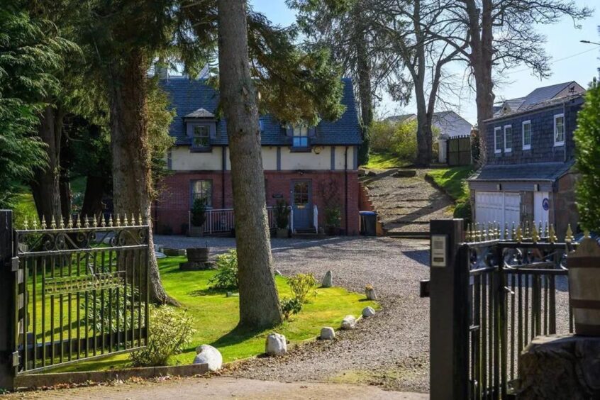 The home is accessed via a private driveway
