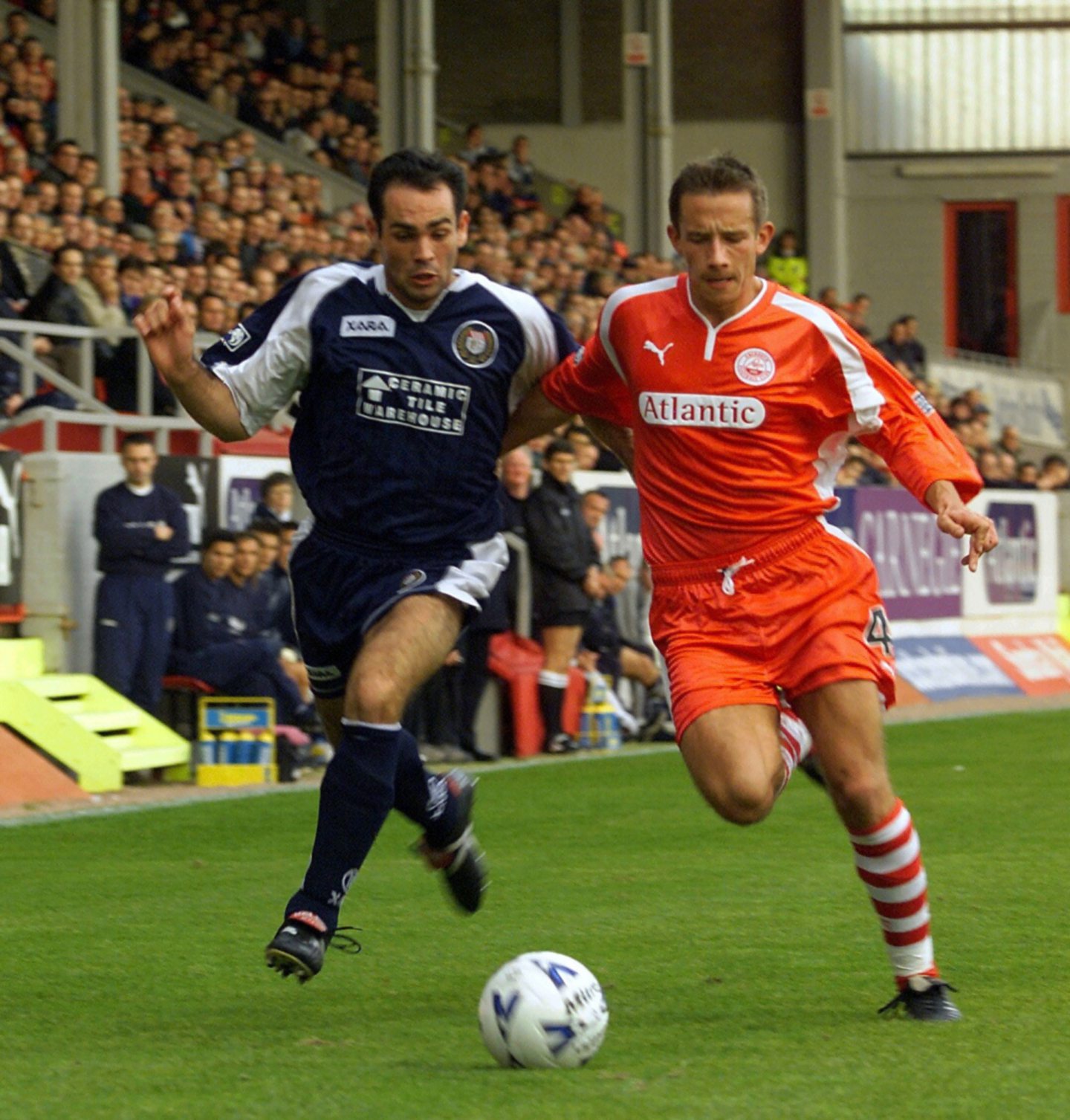 Artero in action for the Dark Blues against Aberdeen, trying to run past a Dons player 