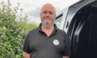 Alan McHattie standing by van