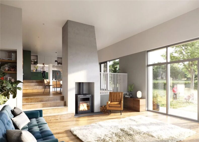 An open-plan living-room with stove and couch.