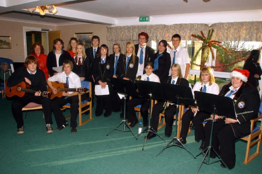 Pupils with instruments perform at Ballumbie Court care home.