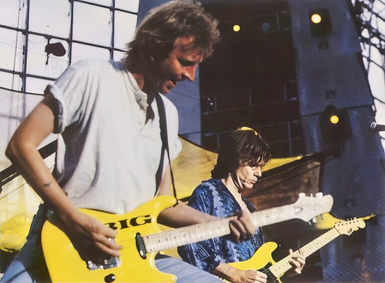 Bruce Watson and Stuart Adamson playing guitar on stage in 1995. 