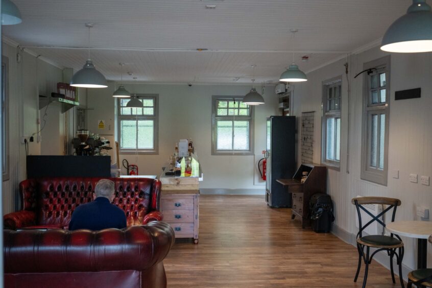 Cafe interior with leather chairs and wooden floor