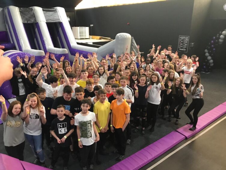 Pupils gather for a group shot at the trampoline park. 
