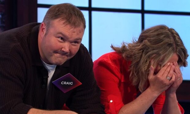 Contestant Craig Smith looks on as wife, Lyndsey cant look on Bridge of Lies BBC quiz show.