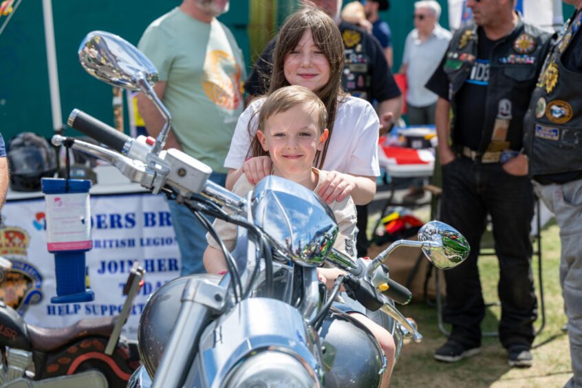Youngsters Clark and Aimee sit on a motorbike as Broughty Ferry Gala Week revs up.