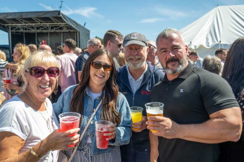 Margaret Duncan, Toni Wiseman, John Smith and Richard Wiseman grab a drink.