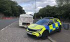A police car parked beside the caravan on Broughty Ferry Road, Dundee.