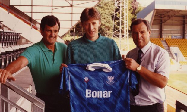 Sergei Baltacha, holding a St Johnstone shirt, with coach Bert Paton and manager Alex Totten in a McDiarmid Park stand in July 1990.