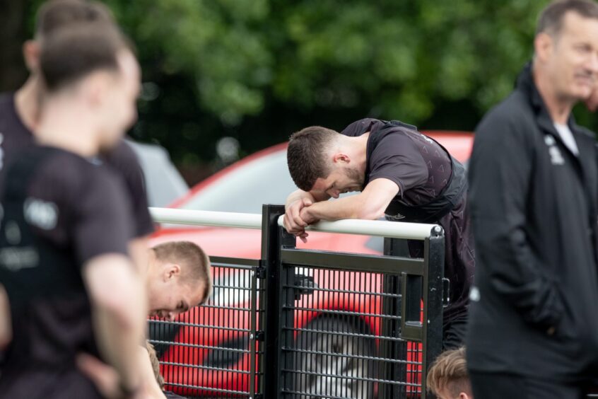 New signing Charlie Gilmour leans over as he recovers during pre-season training.
