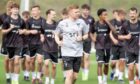 Dunfermline sports scientist Euan Donaldson leads a warm-up run with the Pars players.