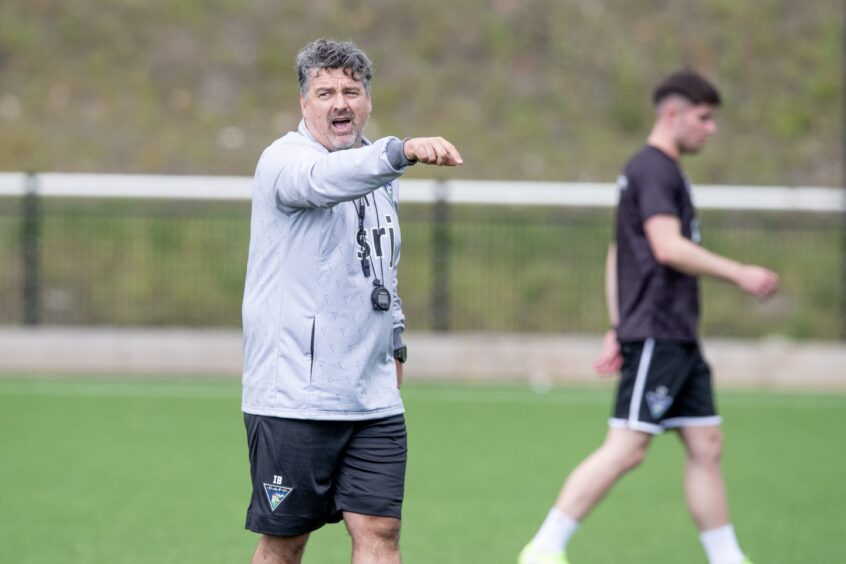Dunfermline assistant Iain Brunskill points and shouts instructions on the training pitch.