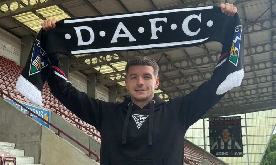 New Dunfermline Athletic signing Charlie Gilmour holds up a DAFC scarf.